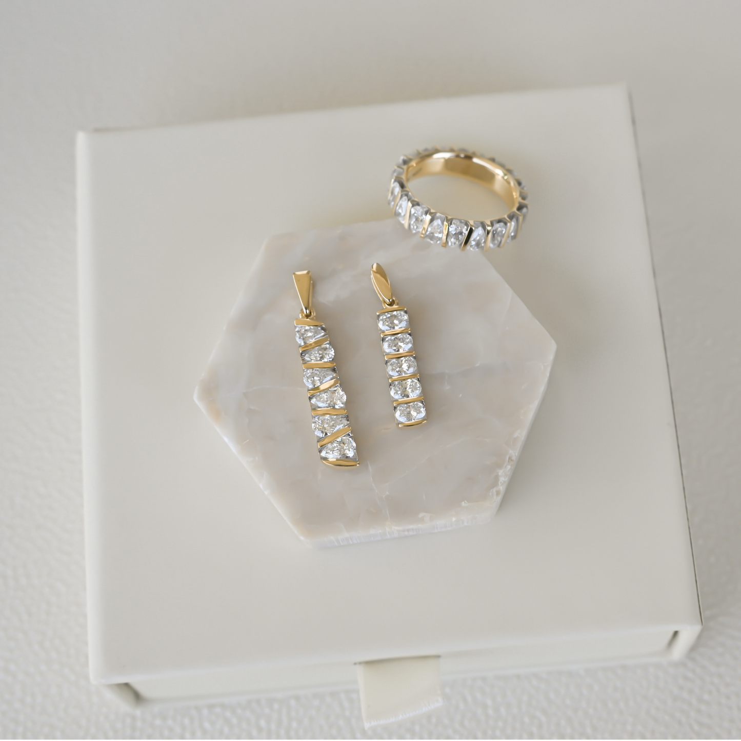 Gold Club by Shannon Hudson display featuring two lab-grown diamond bar pendants and a lab-grown diamond ring in 14k gold