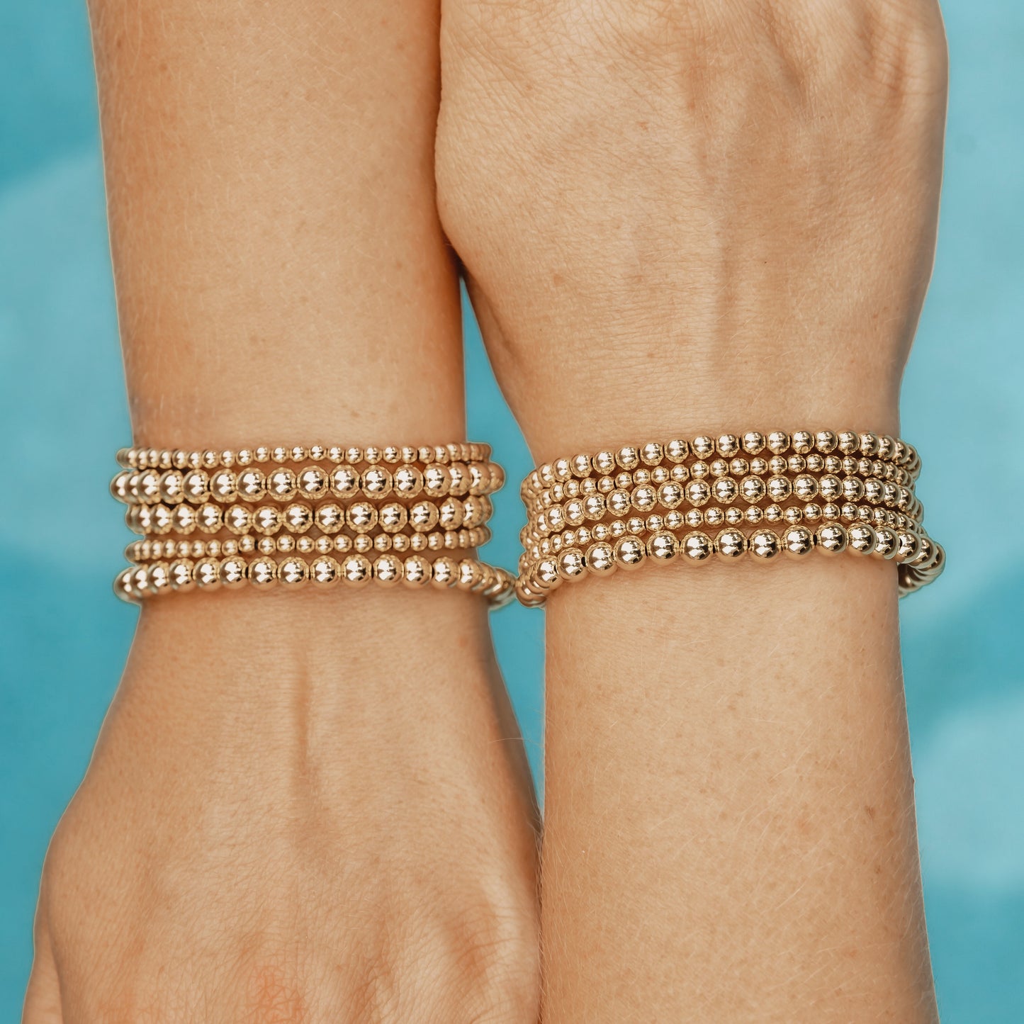Minimalist gold-filled bracelet stacks with flexible LustraFlex™ cord, part of the Gold Club collection.