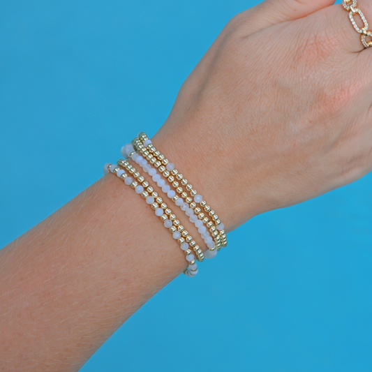 Subtle luxury: white moonstone and gold bracelets worn for day-to-night styling