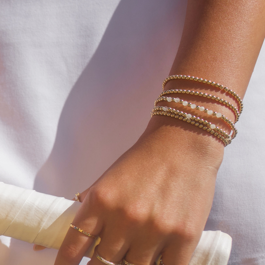Elegant wrist styling with Gold Club by Shannon Hudson White Moonstone bracelets paired with luminous 14k gold-filled beads