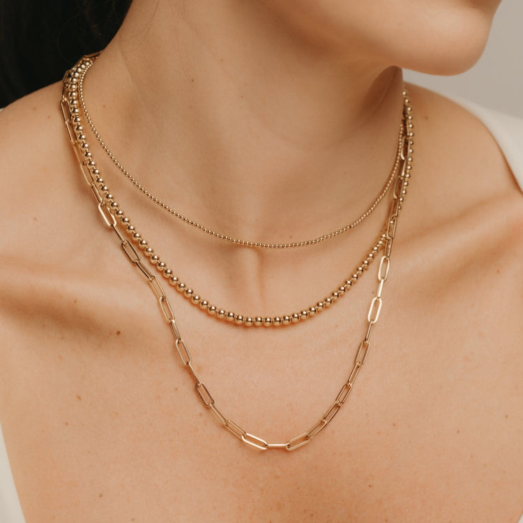 Layered gold-filled necklaces from the Gold Club Everyday collection