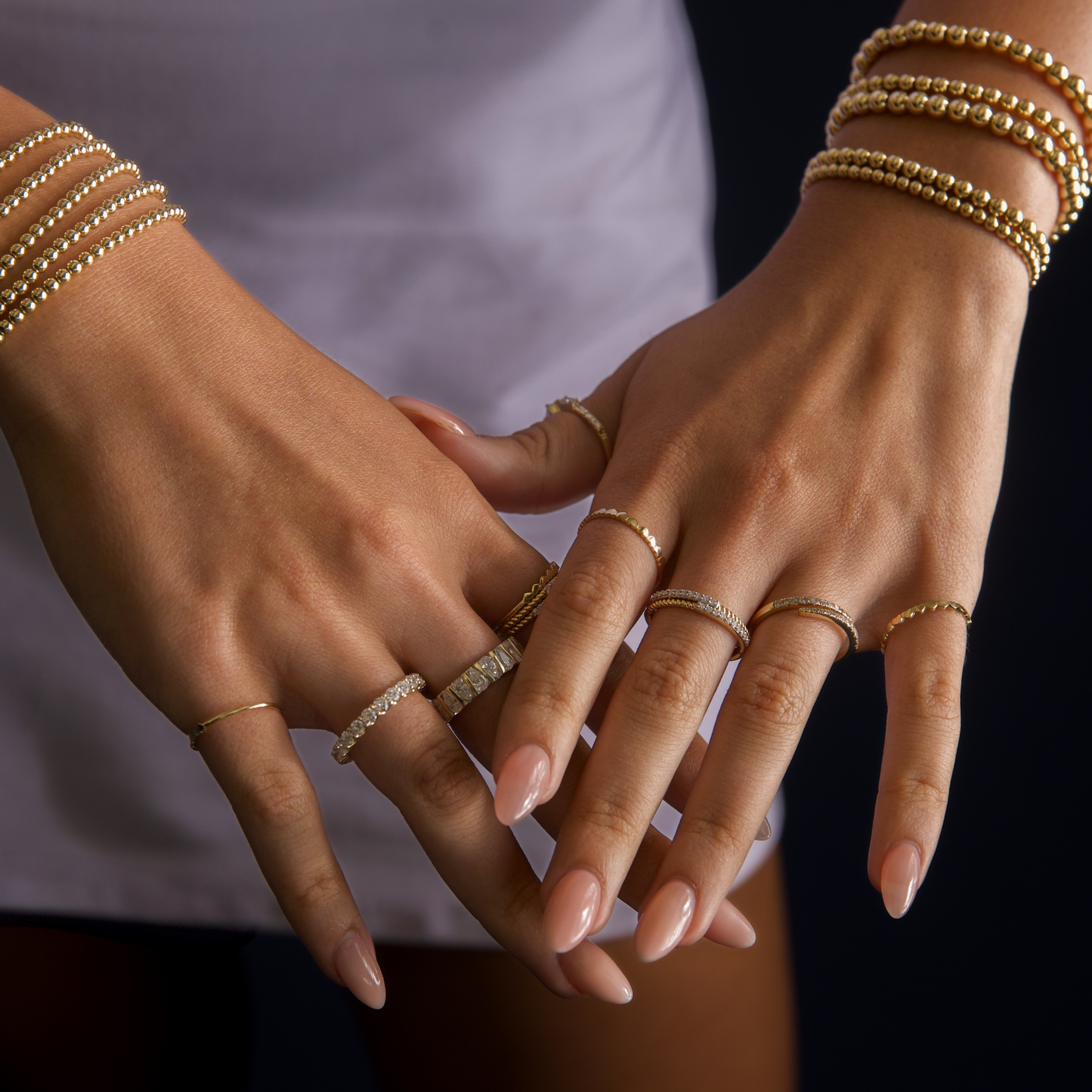 Gold Club by Shannon Hudson styled hands featuring fine jewelry rings paired with gold-filled LustraFlex™ bracelets