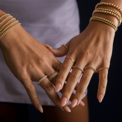 Gold Club by Shannon Hudson styled hands featuring fine jewelry rings paired with gold-filled LustraFlex™ bracelets