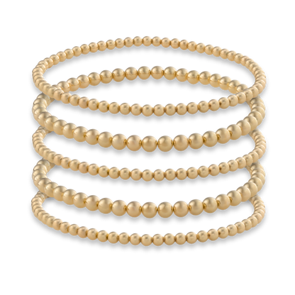 Set of five Gold Club by Shannon Hudson Gold LustraFlex™ Bracelets on a transparent background