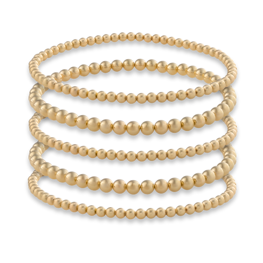 Set of five Gold Club by Shannon Hudson Gold LustraFlex™ Bracelets on a transparent background