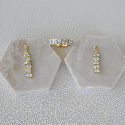 Display of Gold Club by Shannon Hudson fine jewelry featuring two lab-grown diamond bar pendants and a 14k gold diamond ring