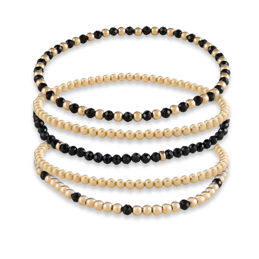 Detailed image of handcrafted natural black onyx gemstone and 14k gold filled bracelet with LustraFlex™ band from Gold Club by Shannon Hudson