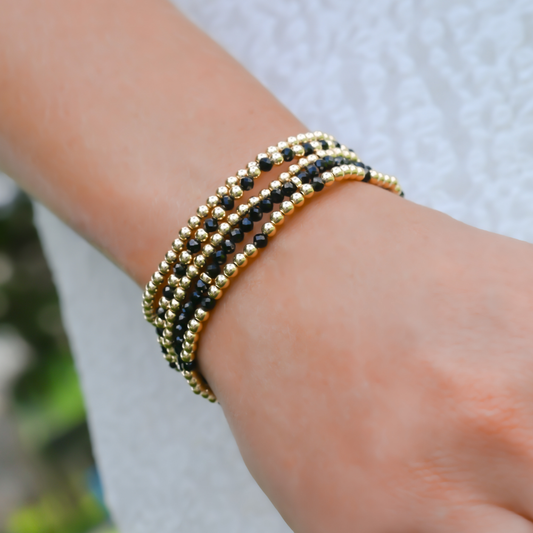 Handcrafted gemstone bracelet from Gold Club featuring black onyx and LustraFlex™ band