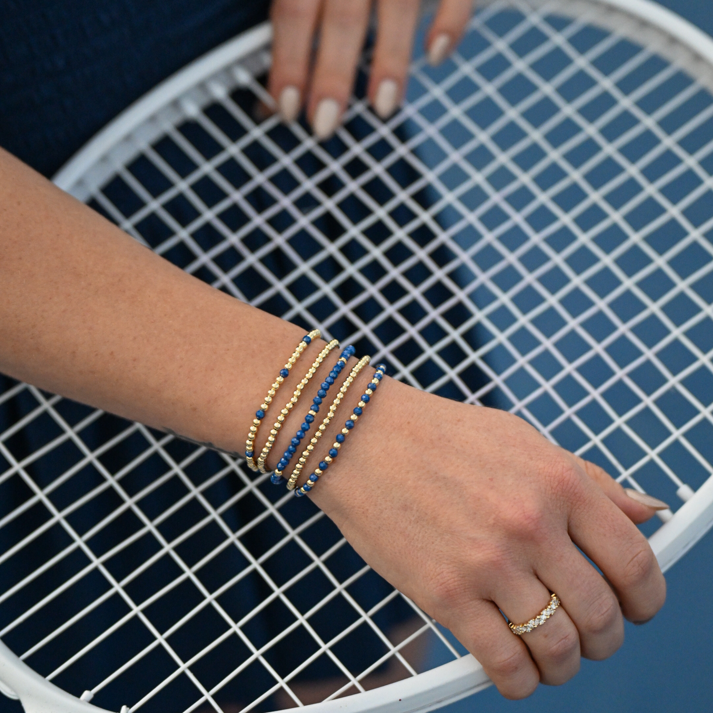 Blue Zircon Signature Stack by Gold Club Jewelry House featuring layered blue zircon and gold beaded bracelets designed for everyday wear and active lifestyles.
