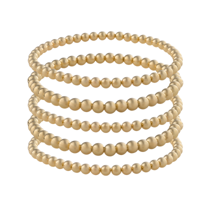 Gold-filled beaded bracelet stack featuring LustraFlex™ technology by Gold Club on a transparent background