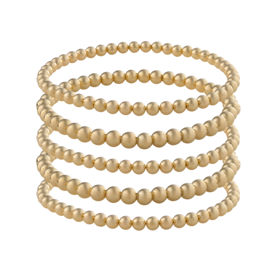 Gold-filled beaded bracelet stack featuring LustraFlex™ technology by Gold Club on a transparent background
