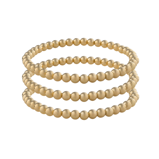 Three gold filled LustraFlex™ bracelets with transparent background. Active lifestyle jewelry. 