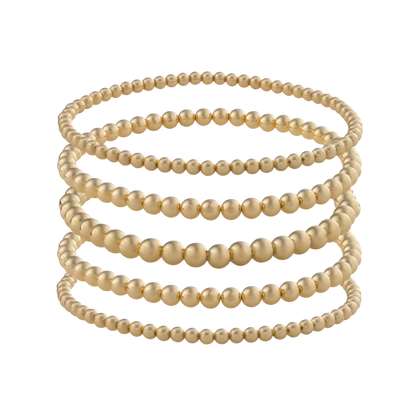LustraFlex™ gold-filled bracelet stack from Gold Club by Shannon Hudson displayed on a transparent background—jewelry that is tarnish resistant, waterproof and sweat proof. 