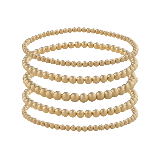 LustraFlex™ gold-filled bracelet stack from Gold Club by Shannon Hudson displayed on a transparent background—jewelry that is tarnish resistant, waterproof and sweat proof. 