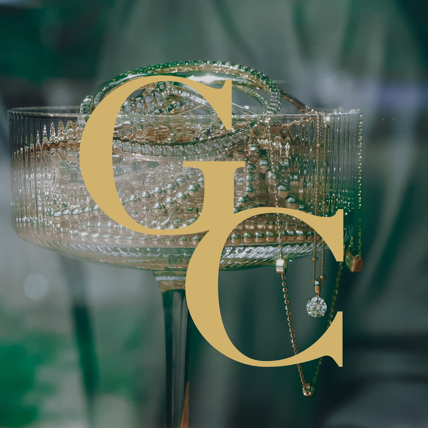 Gold Club logo over a martini glass filled with fine jewelry.
