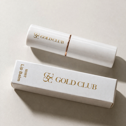 Gold Club lip balm and packaging on a light background