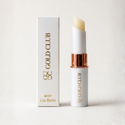 Gold Club lip balm with packaging on a light background