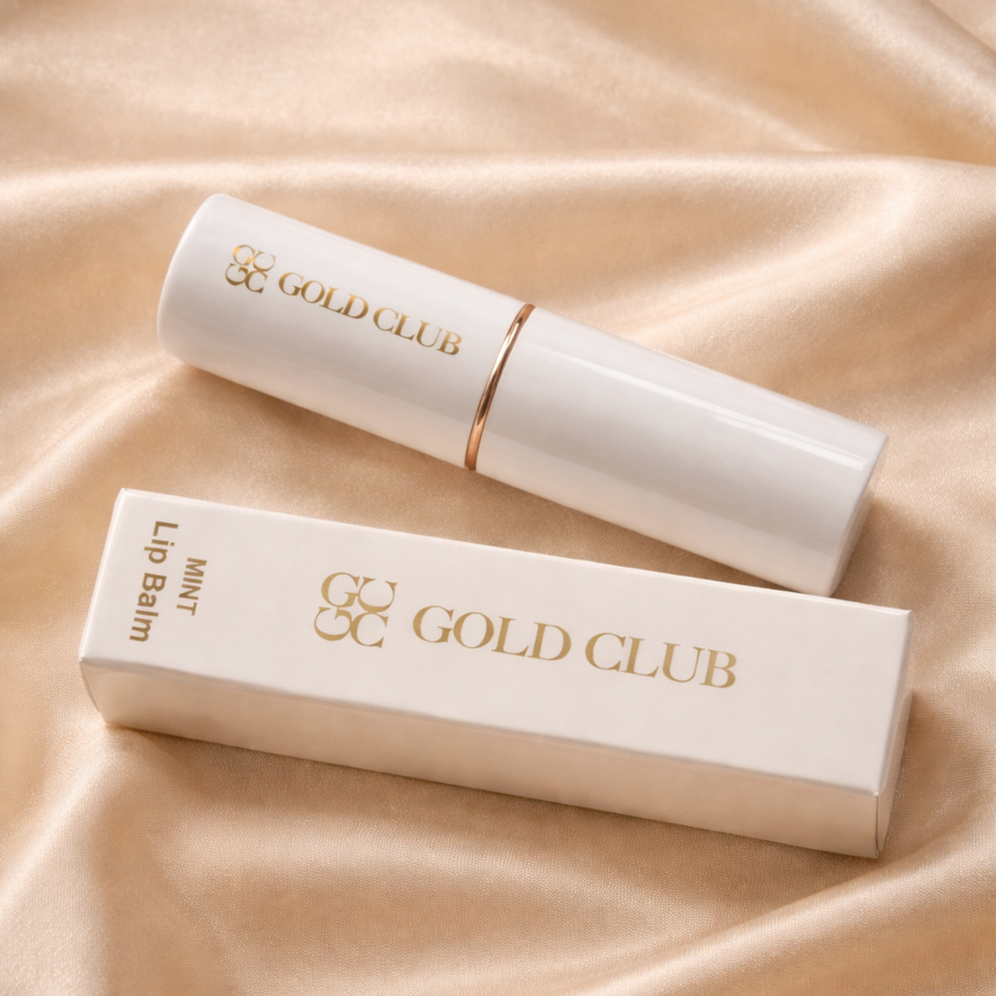 Gold Club natural hydrating lip balm and packaging on a beige fabric background