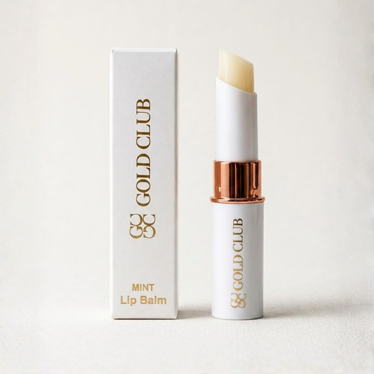 Gold Club lip balm with packaging on a light background