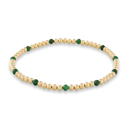 Beaded bracelet with natural green sandstone and gold beads on a transparent background
