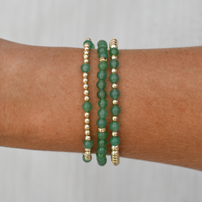 Lifestyle image of the Green Agate stack worn on wrist, combining earthy tones and gold accents for a grounded, everyday luxury look.
