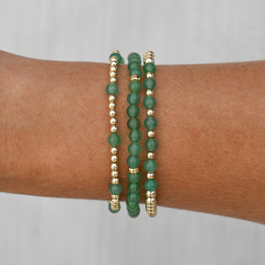 Lifestyle image of the Green Agate stack worn on wrist, combining earthy tones and gold accents for a grounded, everyday luxury look.