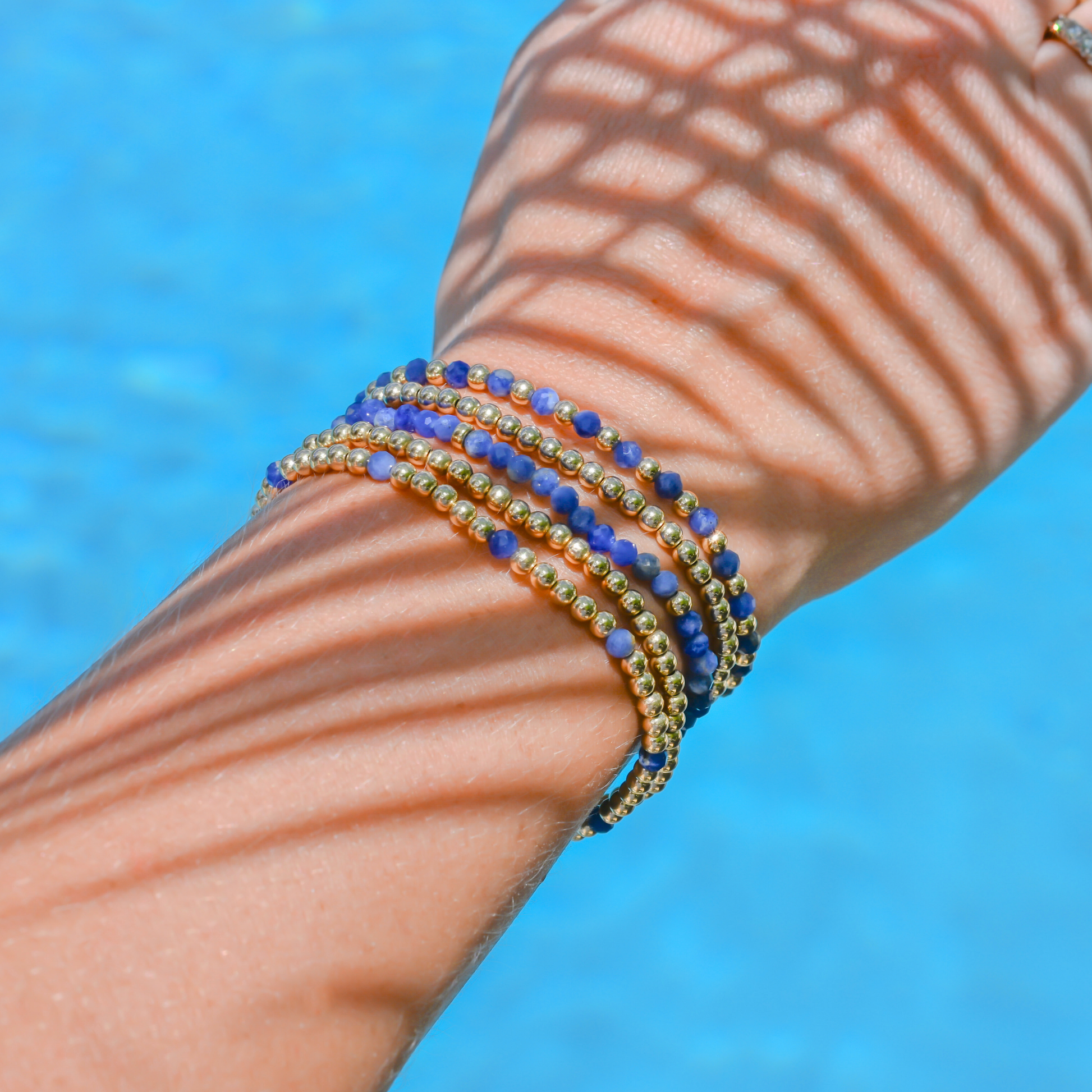 Minimalist gold-filled bracelets with flexible LustraFlex™ cord, part of the Gold Club by Shannon Hudson kyanite gemstone collection.