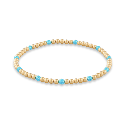 Beaded bracelet with gold and turquoise beads on a white background