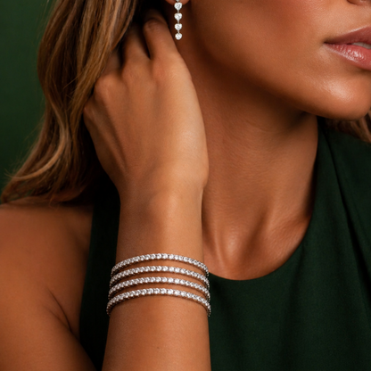 Close-up of a woman wearing a silver bracelet and earrings against a green background Lightweight Tennis Line Bracelet 
