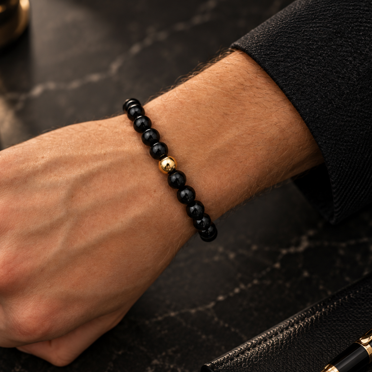Men’s polished black natural stone bead bracelet with gold-filled accent bead