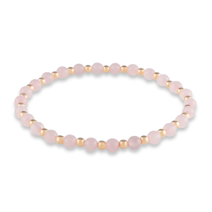 Alternating pink quartz and gold-filled beads in a symmetrical design symbolizing harmony, heart, and emotional strength.