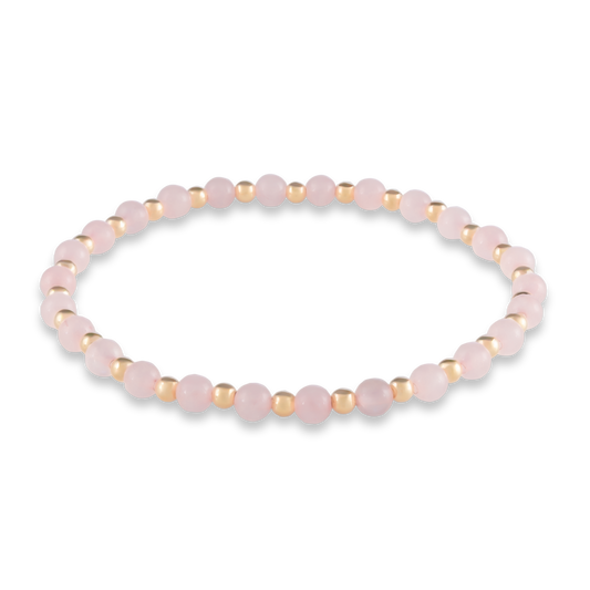 Alternating pink quartz and gold-filled beads in a symmetrical design symbolizing harmony, heart, and emotional strength.