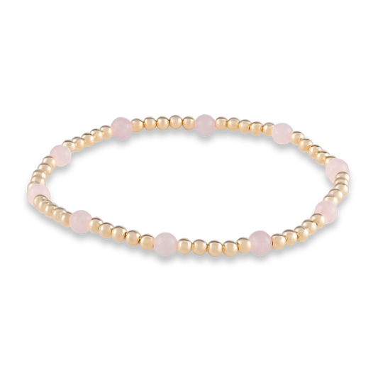 Delicate yet powerful, this Muse bracelet blends gold and pink quartz in a flowing pattern that represents love in motion.