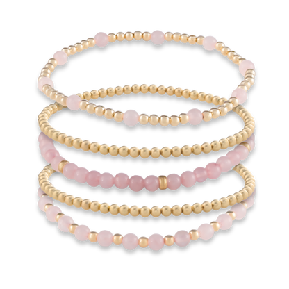 Five-bracelet Signature Stack in Pink Quartz from GOLD CLUB, combining gemstone-rich designs with classic gold-filled layers.