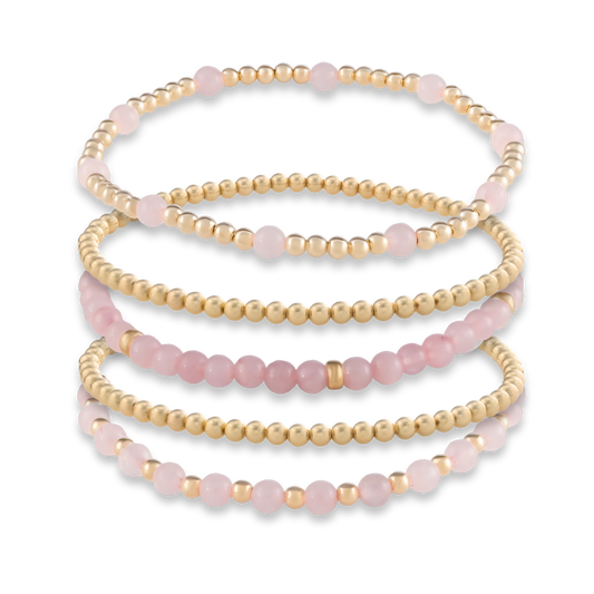 Five-bracelet Signature Stack in Pink Quartz from GOLD CLUB, combining gemstone-rich designs with classic gold-filled layers.