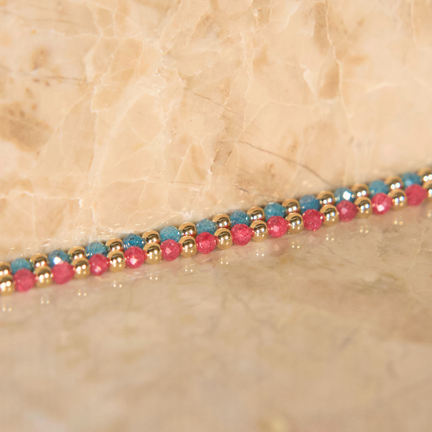 Light blue and pink zircon necklaces on a natural stone