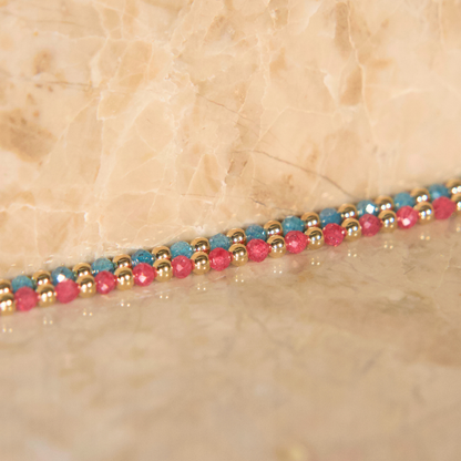 Light blue and pink zircon necklaces on a natural stone