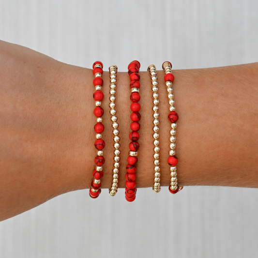 Detailed image of the Red Agate Signature Stack from GOLD CLUB, featuring layered gold-filled and gemstone bracelets styled together. Razorback Jewelry.