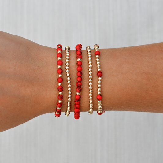 Detailed image of the Red Agate Signature Stack from GOLD CLUB, featuring layered gold-filled and gemstone bracelets styled together.