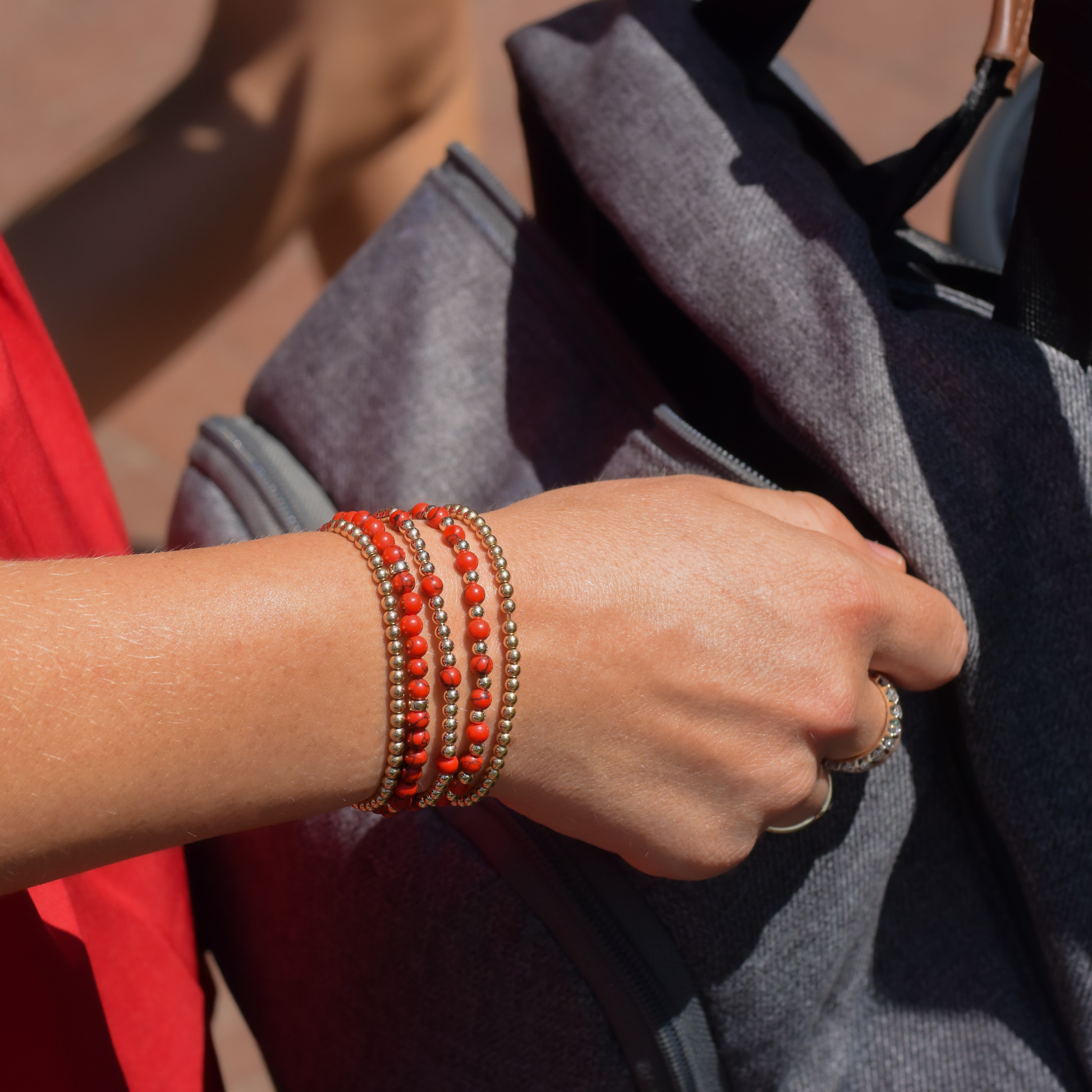 A mom wearing Razorback jewelry styled in Fayetteville Arkansas. Pieces are from Gold Club by Shannon Hudson Everyday collection.