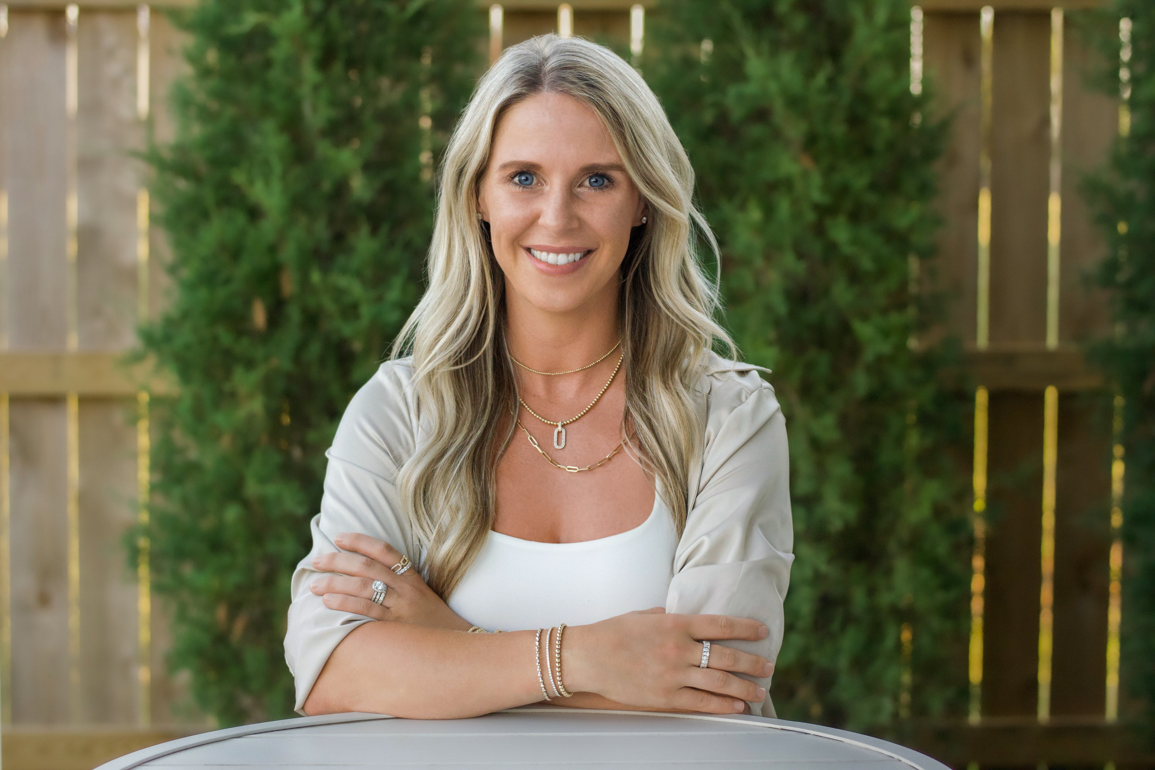 An outdoor headshot of Shannon Hudson with Gold Club Jewelry.