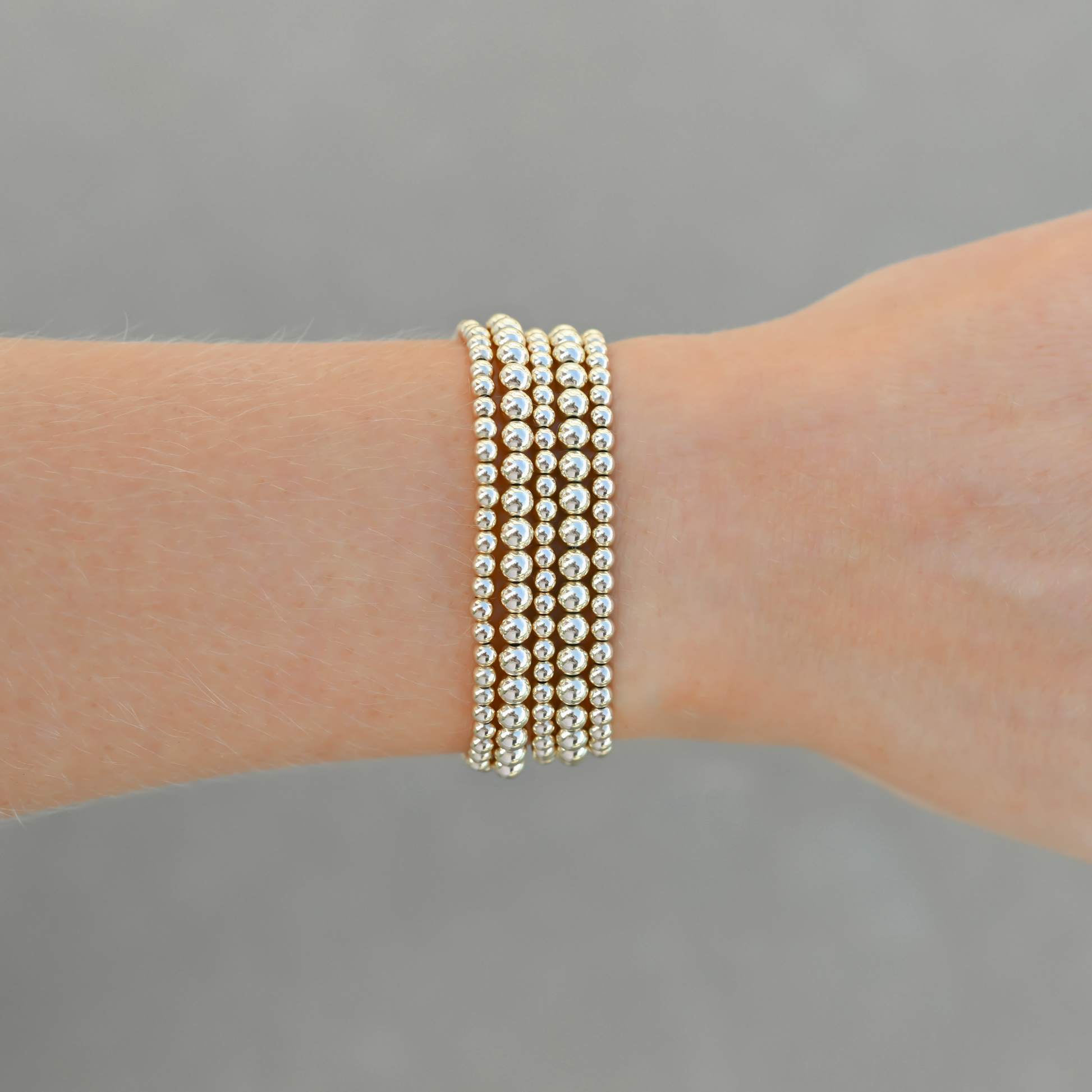 Close-up of Gold Club’s LustraFlex™ gold-filled bracelet stack Shannon Signature
