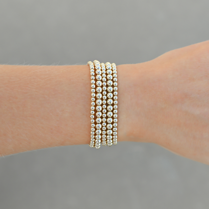 Close-up of Gold Club’s LustraFlex™ gold-filled bracelet stack Shannon Signature