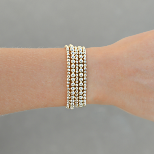 Close-up of Gold Club’s LustraFlex™ gold-filled bracelet stack Shannon Signature