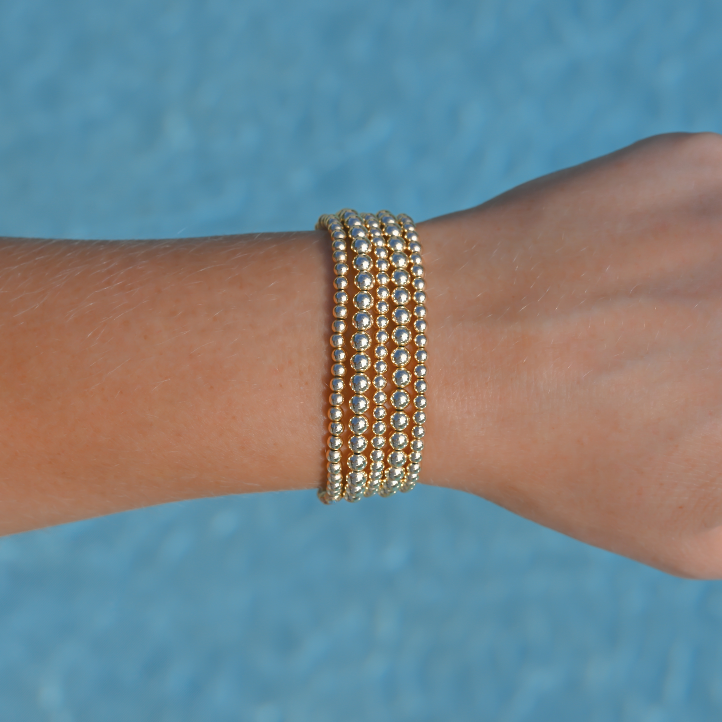 Signature Stack Gold Club by Shannon Hudson bracelet styled for a casual pool party.