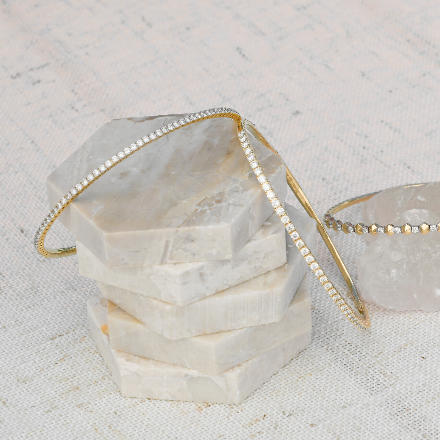 Display of two Gold Club Signature Flex Bangles with lab-grown diamonds alongside one Hex Flex Bangle in gold-filled design