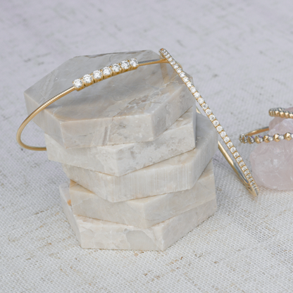 Flex bangles with prominent lab-grown diamonds displayed in 14k gold, fine jewelry by Gold Club by Shannon Hudson